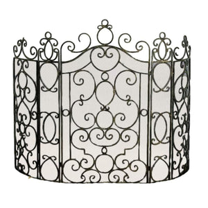 Decorative metal fireplace screen with intricate designs on a white background
