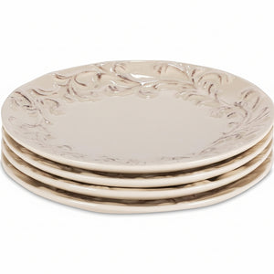 Set of four decorative ceramic plates with intricate designs on a white background