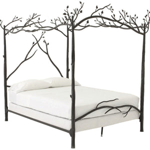 A canopy bed with a hand-forged iron frame featuring a leafy branch design and a white mattress.