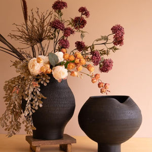 Two black crackle clay vases styled with dried florals