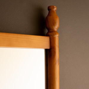 Close-up of turned wood finial on mirror frame