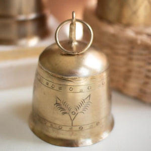 Close-up of hand-etched pattern on antique brass bell