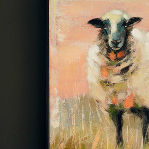 Sheep canvas painting hung above a sofa