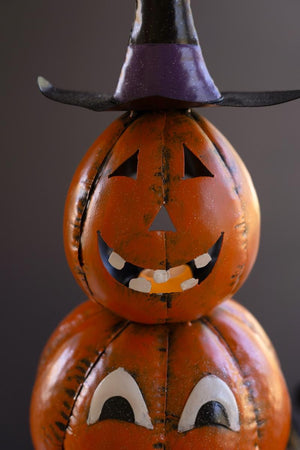 Close-up of purple witch hat on top jack-o-lantern