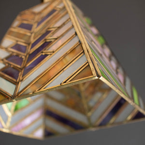Detail of the stained glass panes and brass-tone frame