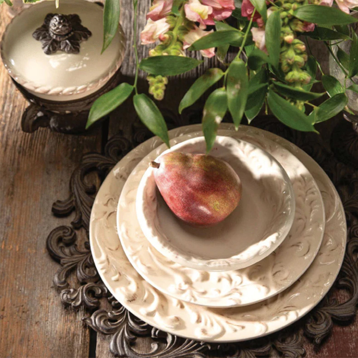 Cream ceramic dinnerware with raised decorative detail