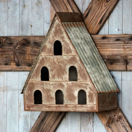 Decorative metal bird house for a garden setting