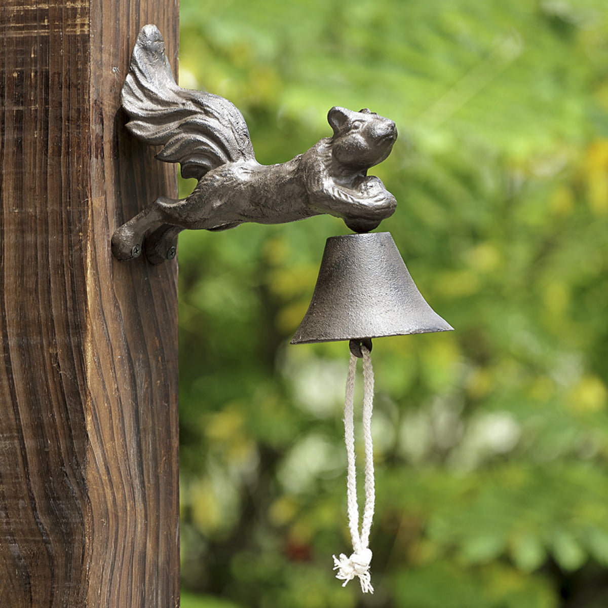 Decorative squirrel garden bell and wind chime mounted outdoors