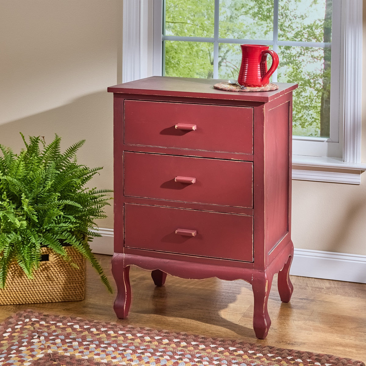 Decorative storage cabinet with drawers in a distressed red painted finish