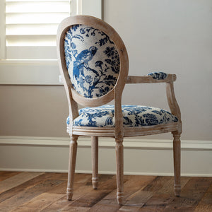 Chair with blue floral patterned fabric on a wooden floor