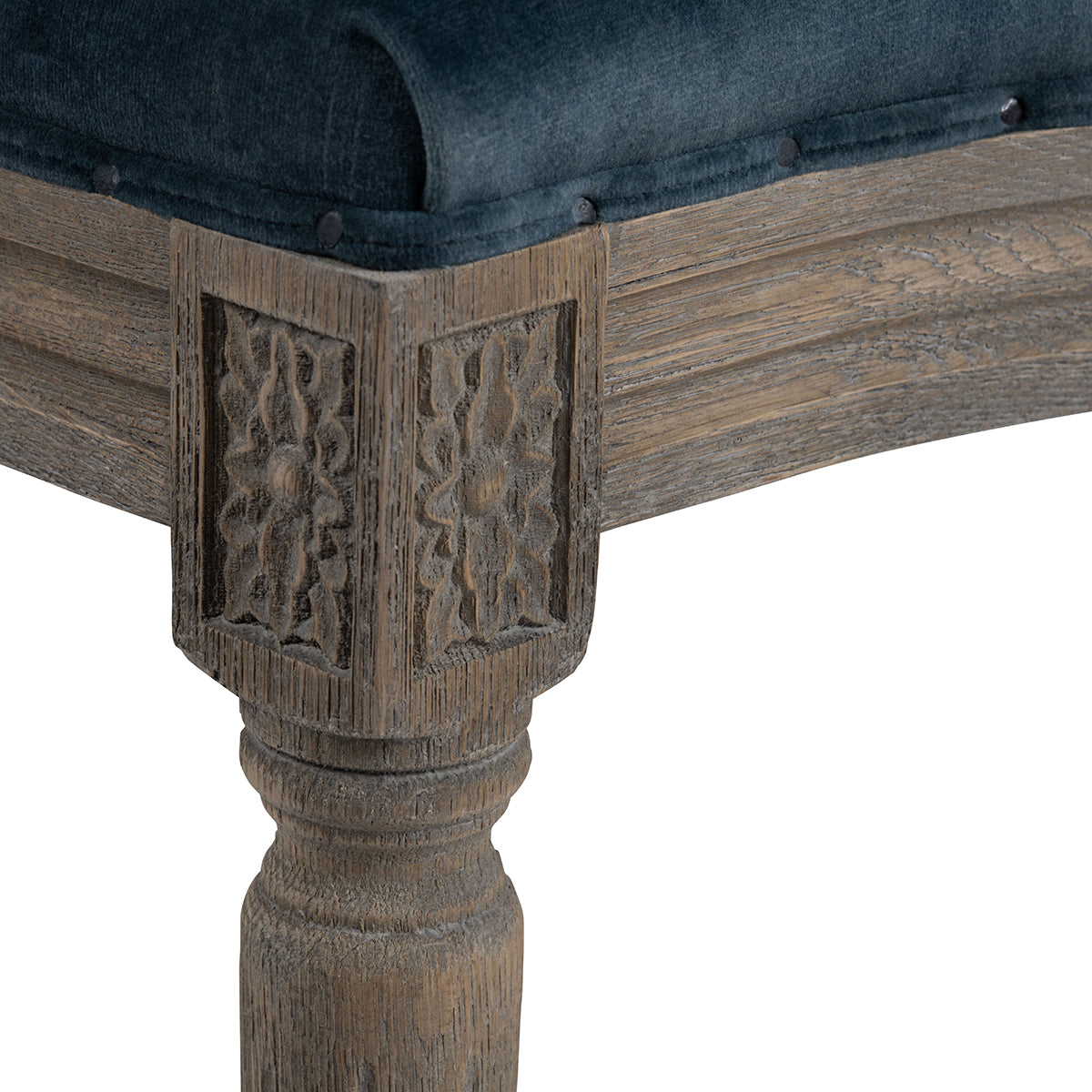 Chair with blue cushion and wicker backrest in a room with wooden floor and furniture.