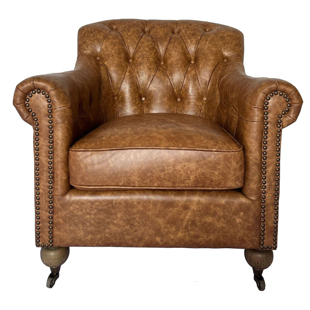 A classic Chesterfield armchair upholstered in distressed brown leather, featuring tufted button detailing on the backrest, rolled arms with nailhead trim, and dark wooden legs with casters. The chair is shown against a plain white background with a model number and dimensions printed below.