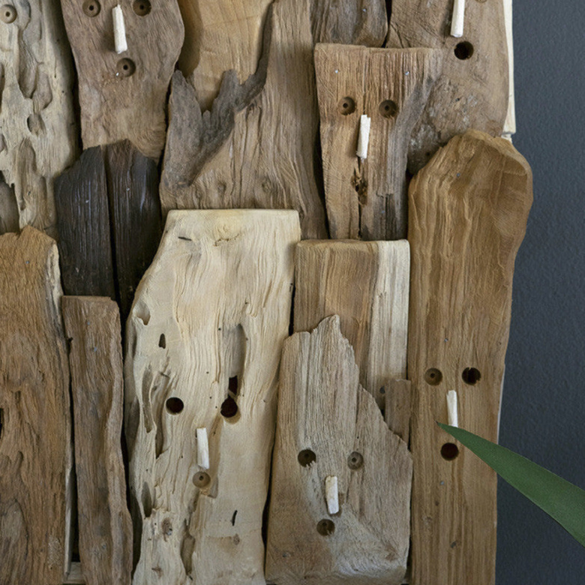 Repurposed Driftwood Faces Wall Art - This crowd of surprised onlookers would be perfect for a shower room at a beach house. Hang this driftwood faces wall art as the centerpiece of your repurposed wood collection or make it a funny piece where you expect guests to get naked.  - 24" x 2.5" x 24"t
