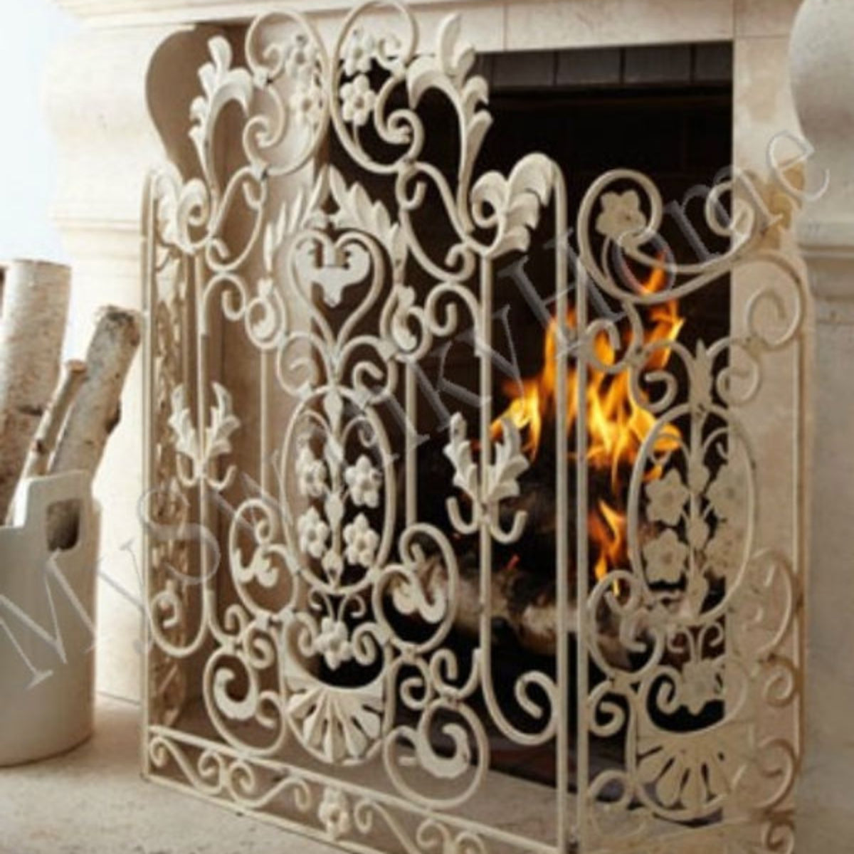 Decorative fireplace screen with intricate designs in front of a lit fireplace.
