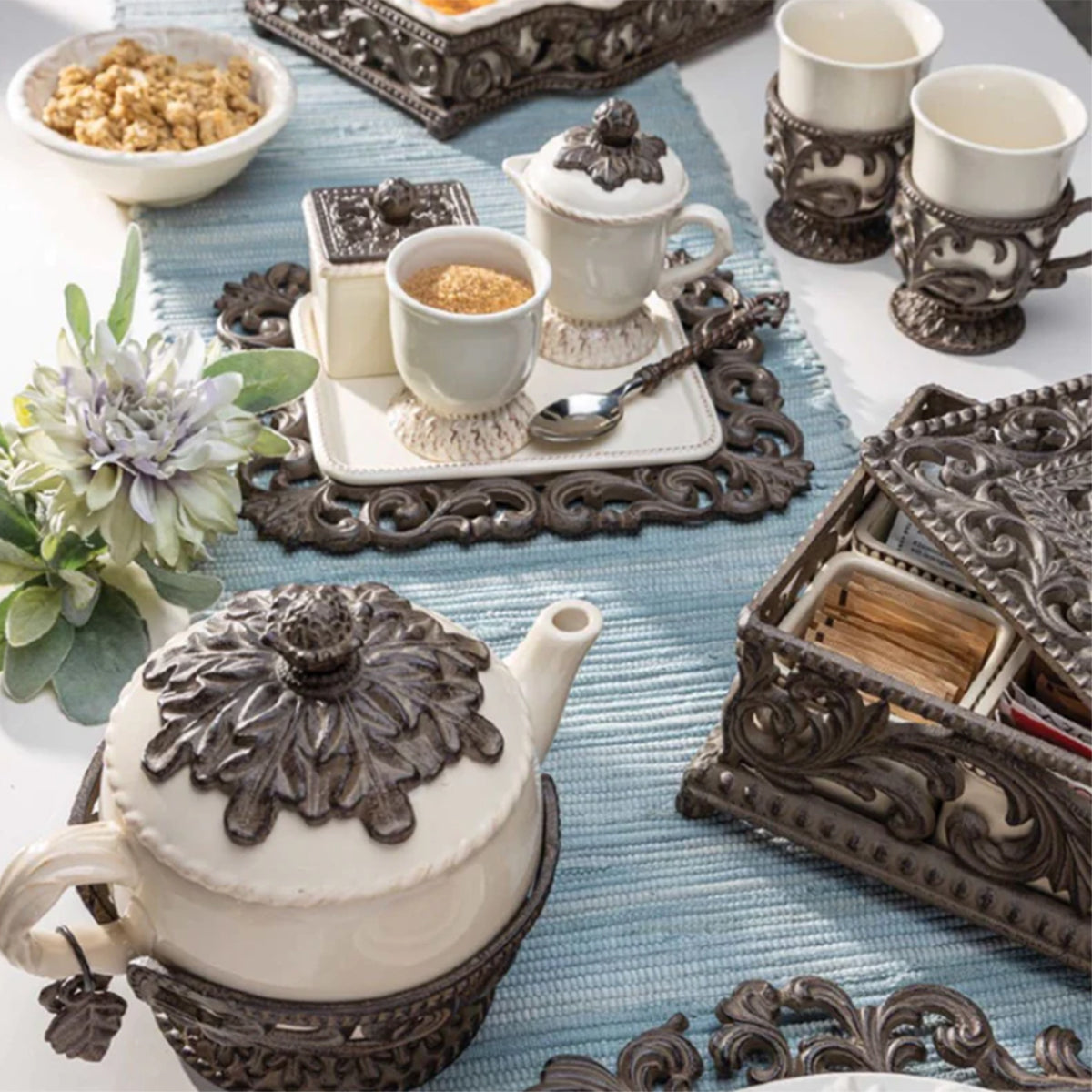 Ceramic serveware displayed with decorative metal accents