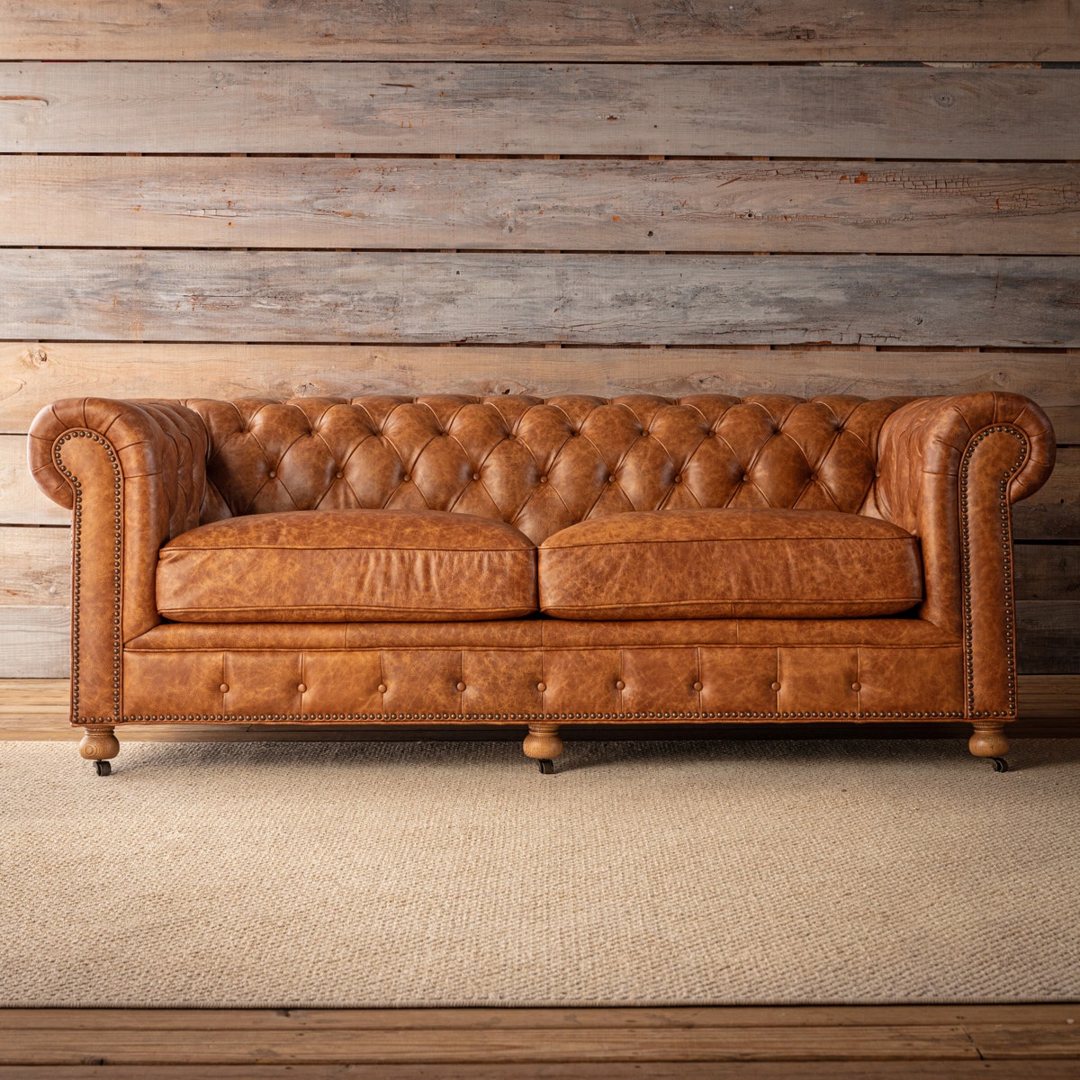 Distressed leather chesterfield sofa with classic tufting
