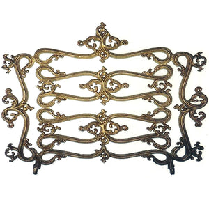 Decorative metal fireguard with intricate designs on a white background