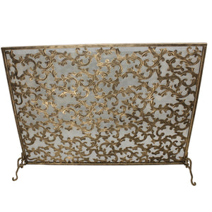 Decorative fireplace screen with intricate gold patterns on a white background