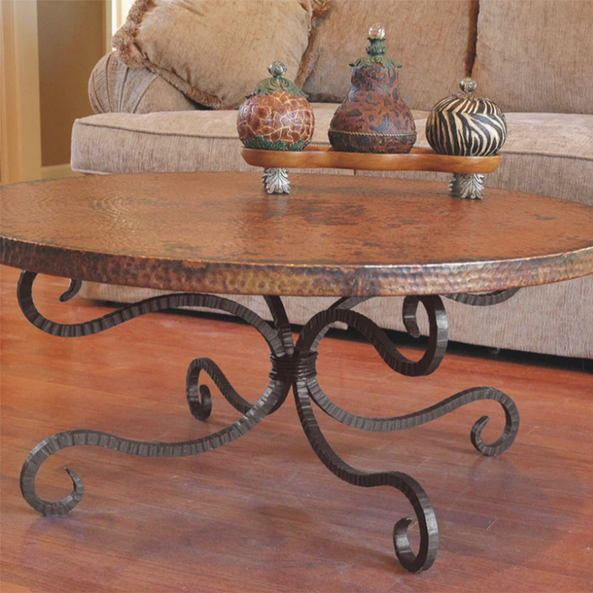 Artisan-forged iron cocktail table with a hammered metal top