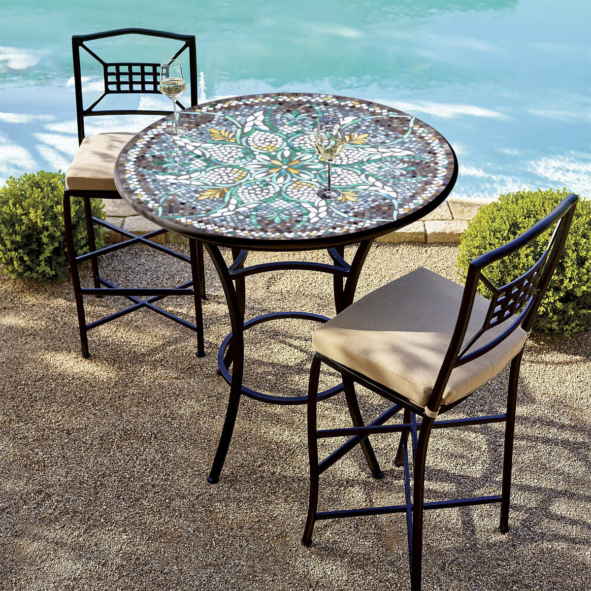 Ojai Valley design patio table with glass mosaic in earthy greens and golds accompanied by two chairs.