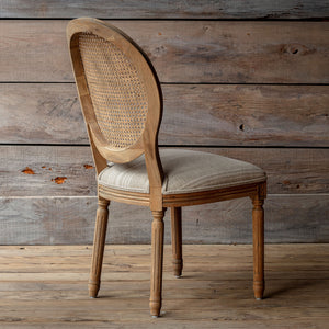 Wooden chair with wicker backrest against a wooden wall. Rosemere Round Cane-Back Dining Chair