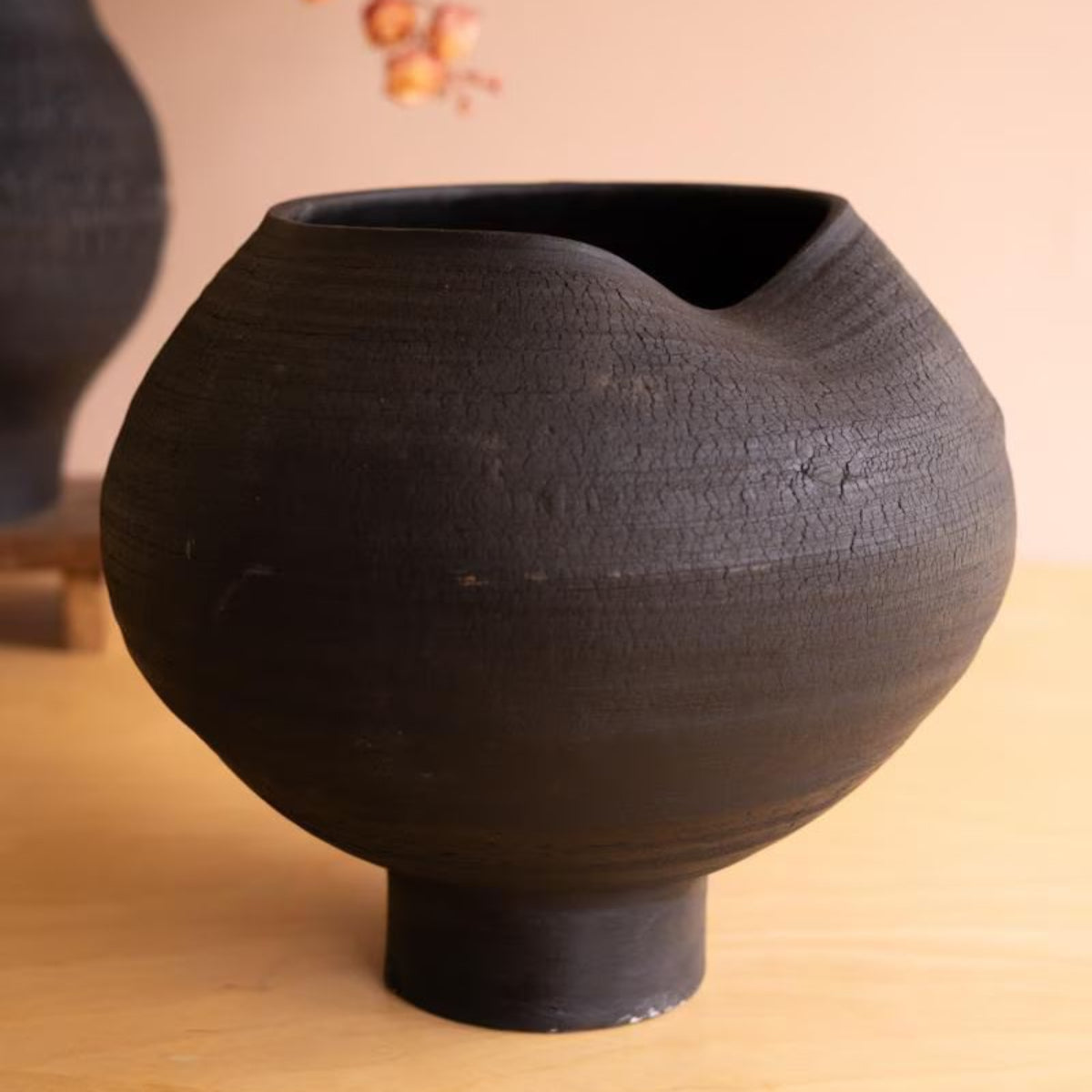 Close-up of rounded black crackle vase