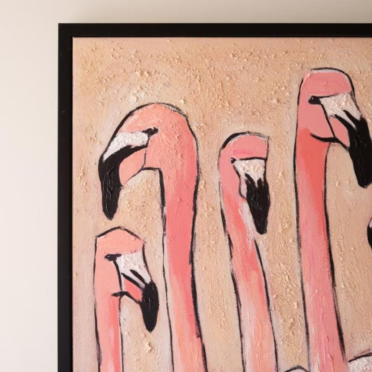 Close-up of flamingos and black frame on painted canvas