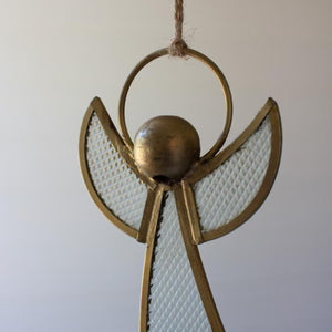Close-up of brass and pebble glass angel ornament