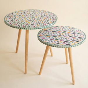 Two capiz fish mosaic accent tables with tapered wood legs on a white background