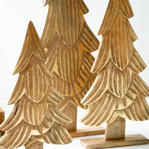 Three carved mango wood Christmas trees in graduated sizes