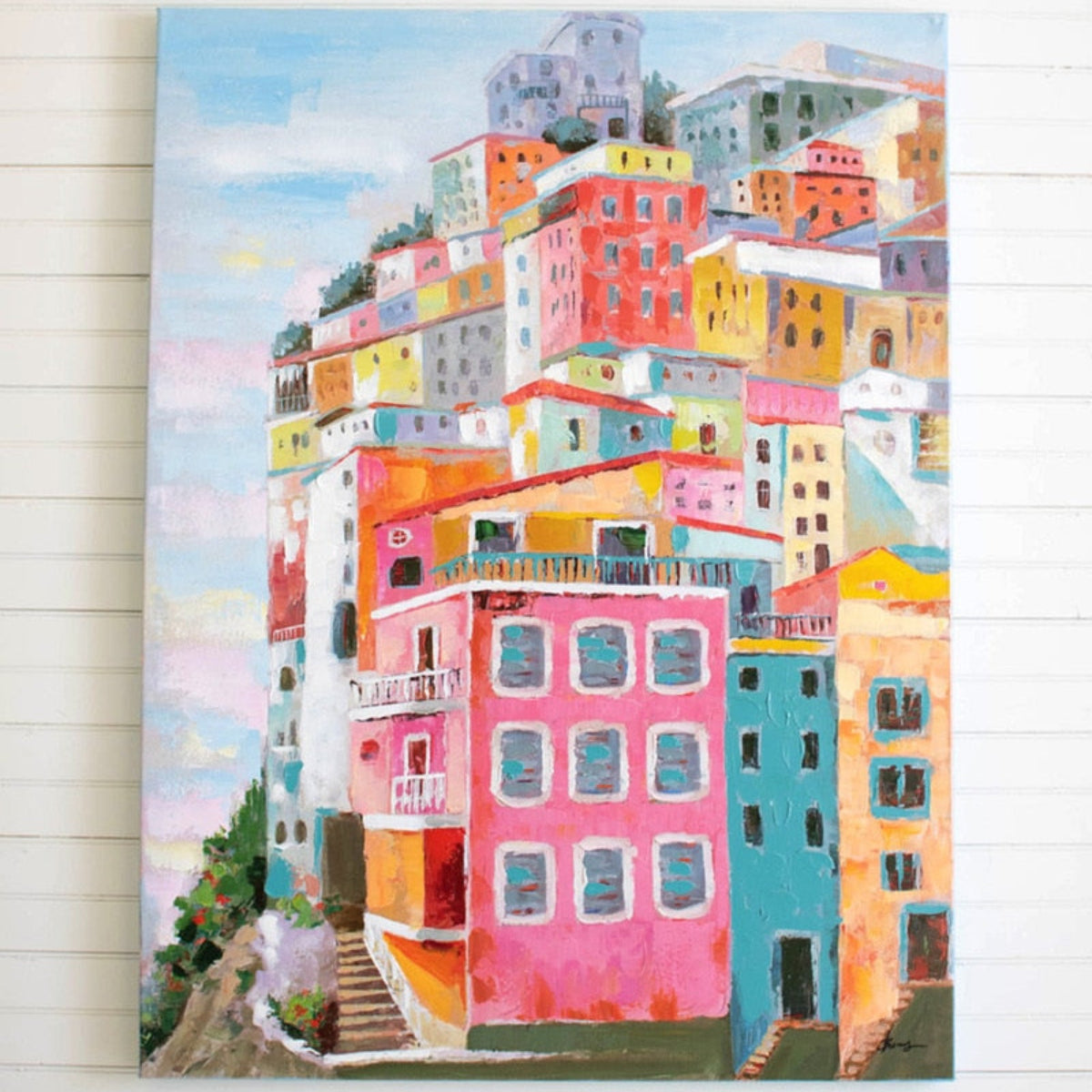 Coastal houses oil painting hung above a sofa