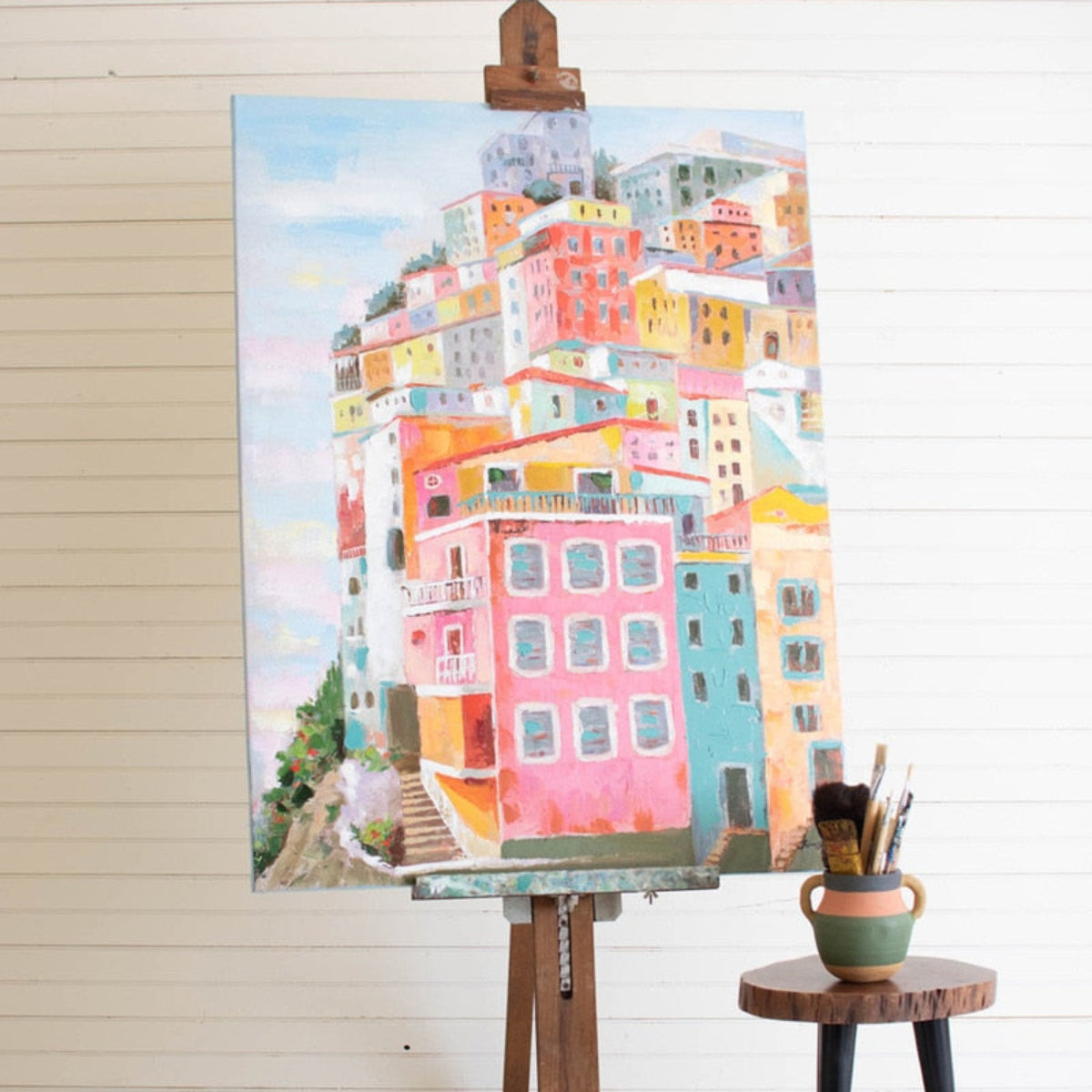 Hand-painted oil painting of colorful stacked coastal houses