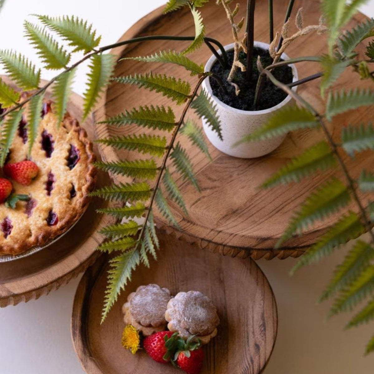 Overhead view of etched wood serving stands with treats