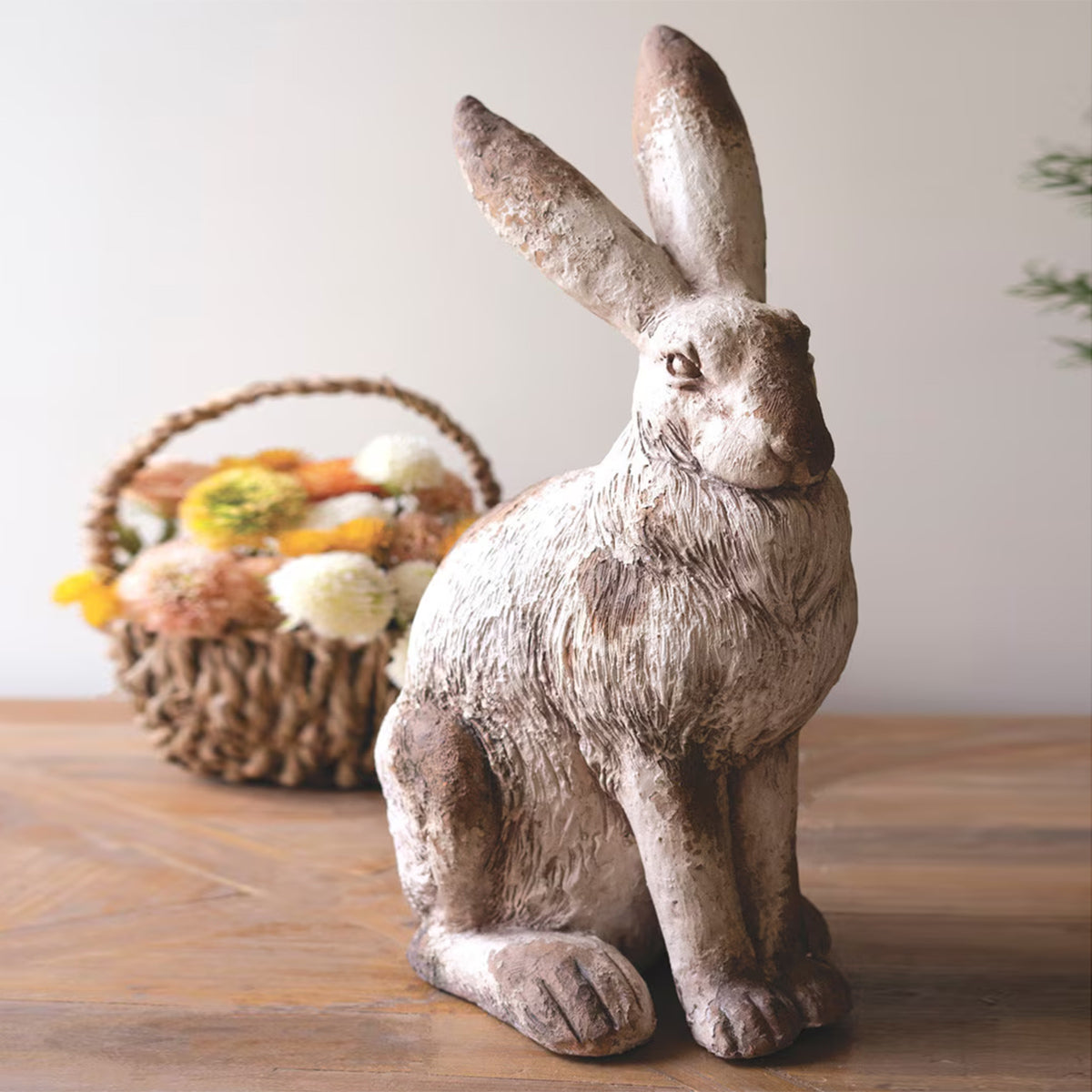 Faux concrete rabbit sculpture in earthy tones