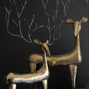Close-up of antique gold reindeer head and branch-like metal antlers