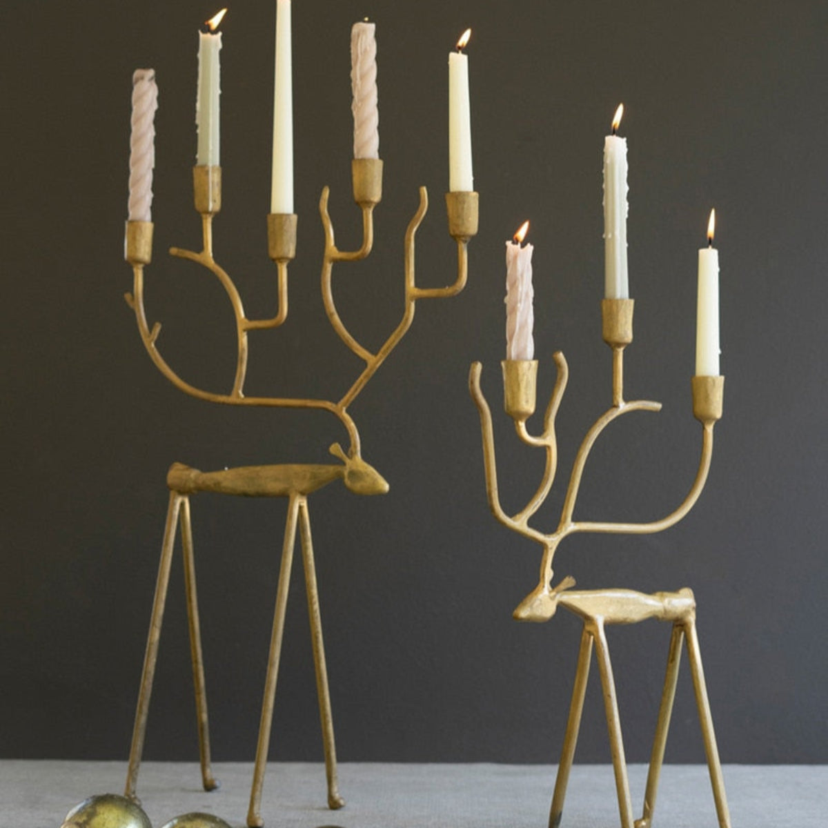 Two gold forged iron reindeer taper candelabras