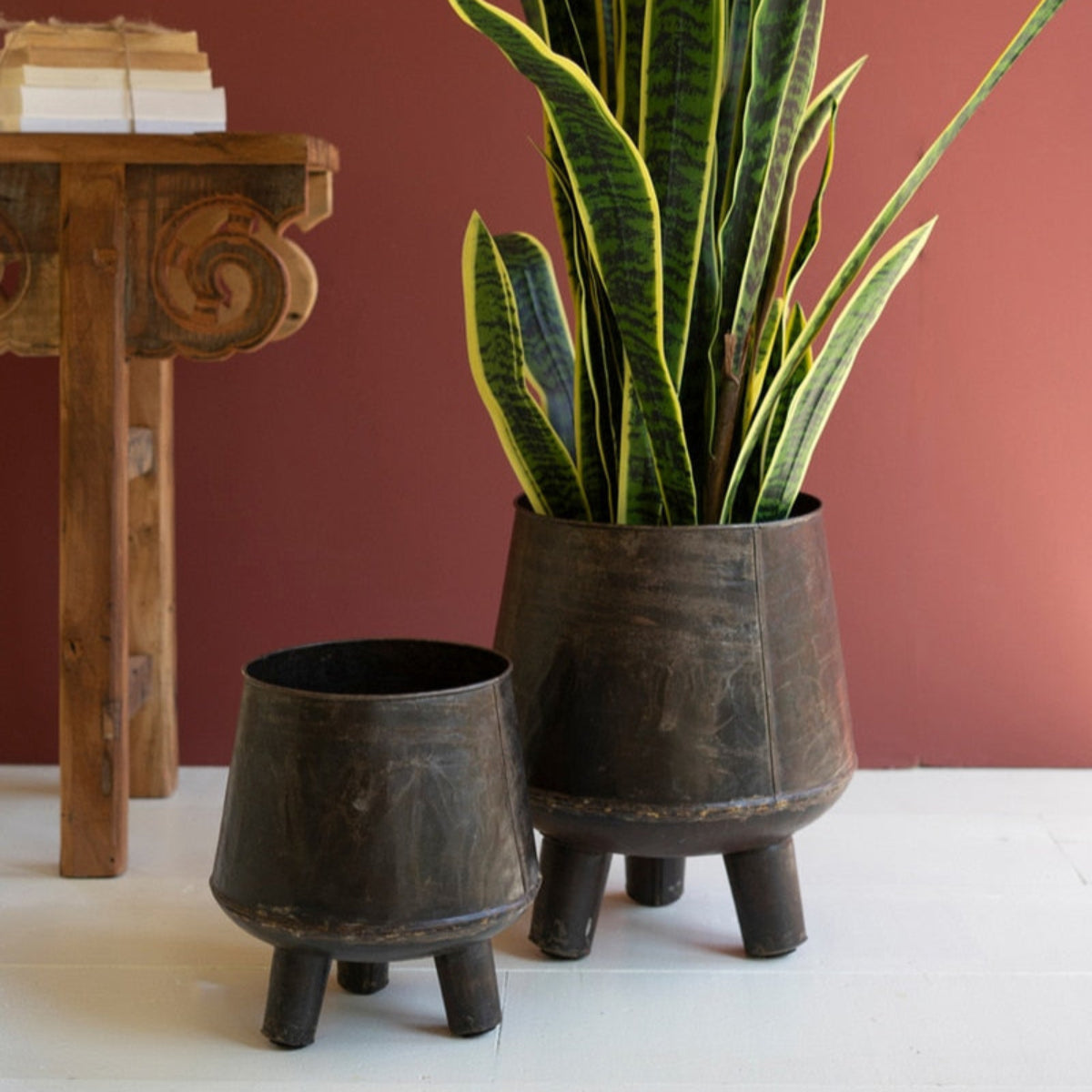 Two hand-hammered iron planters on legs