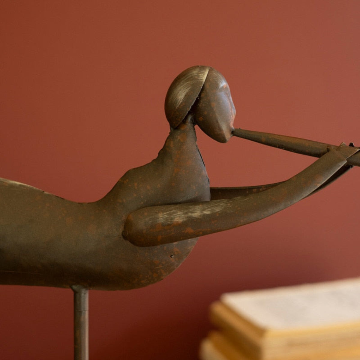 Two distressed metal trumpeting angel sculptures