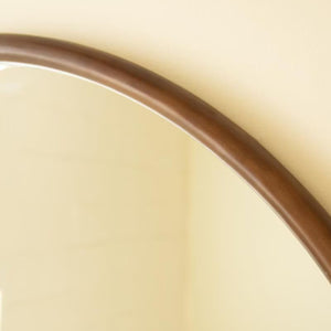 Close-up of slim stained wood mirror frame edge