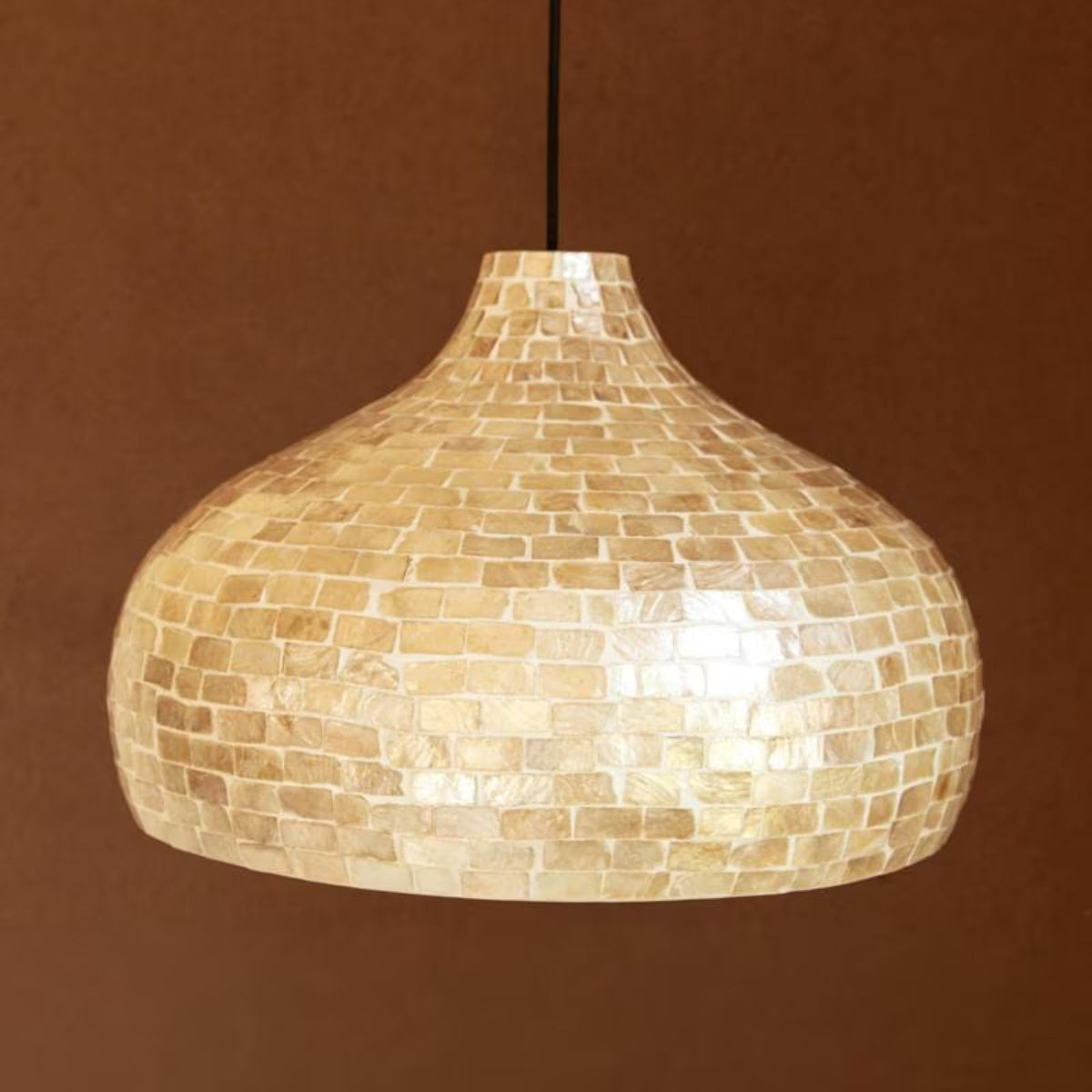Pearl Dome Capiz and Bamboo Pendant Light hanging in a room