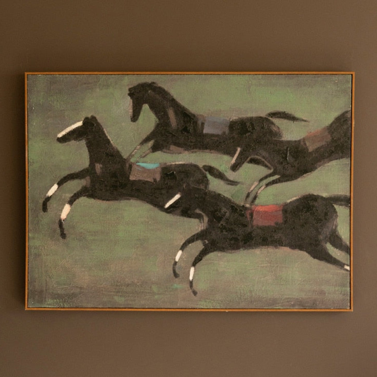 Race horses painting hung on a wall