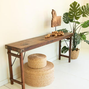 Side view of the rustic folding console table with greenery
