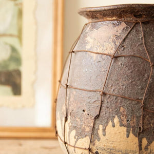 Close-up of textured brown clay and wire cage detail