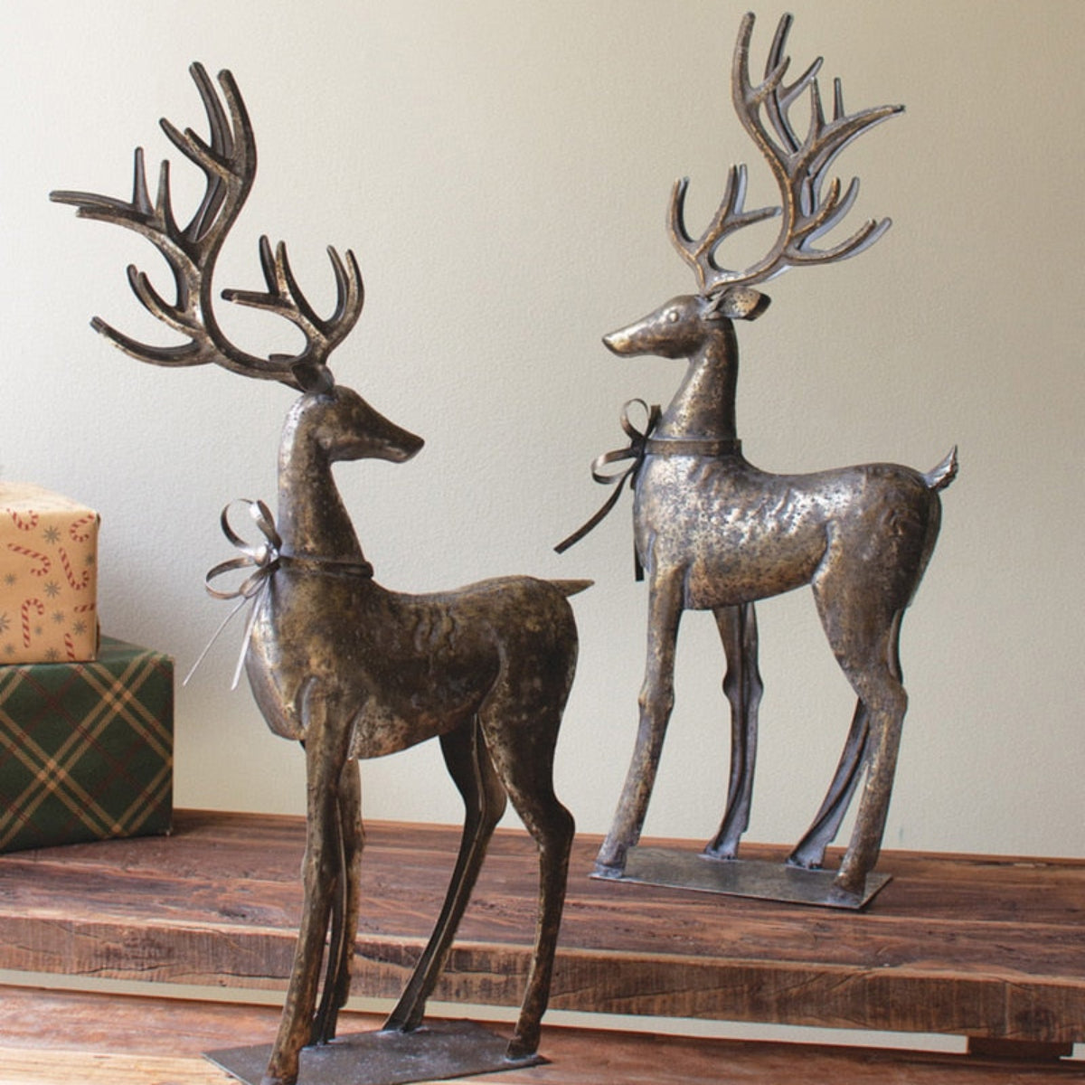 Two distressed grey metal reindeer