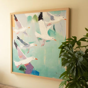 Angled view of framed seagull canvas with greenery