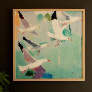 Coastal seagull canvas hung on a dark wall
