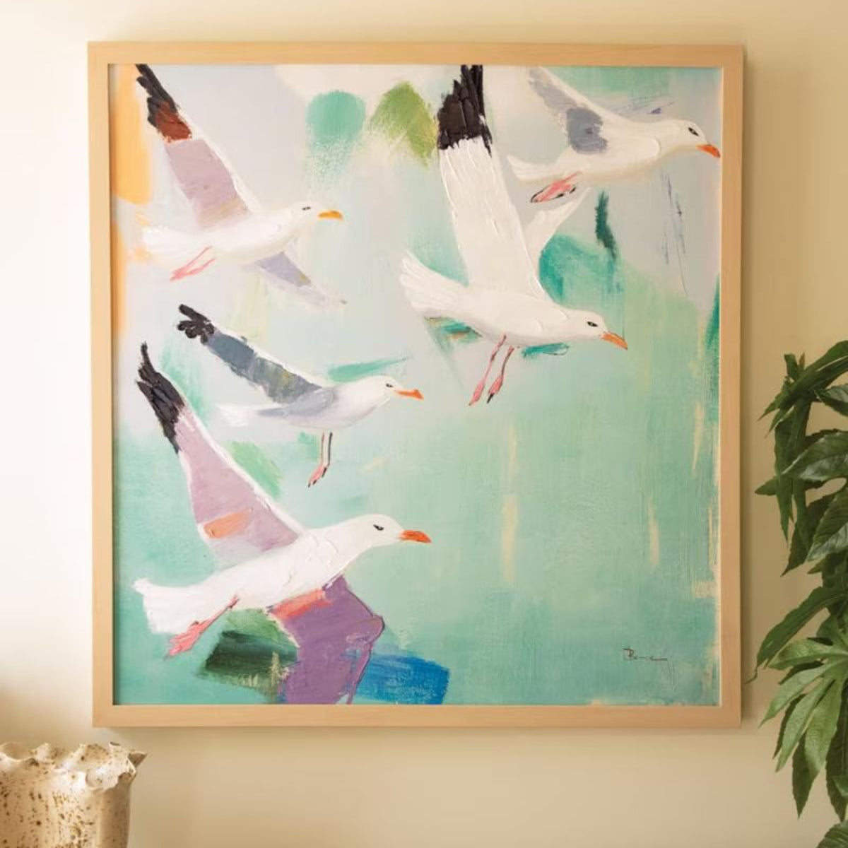 Seaside Gulls in Flight Canvas Art, framed coastal painting hung above a console