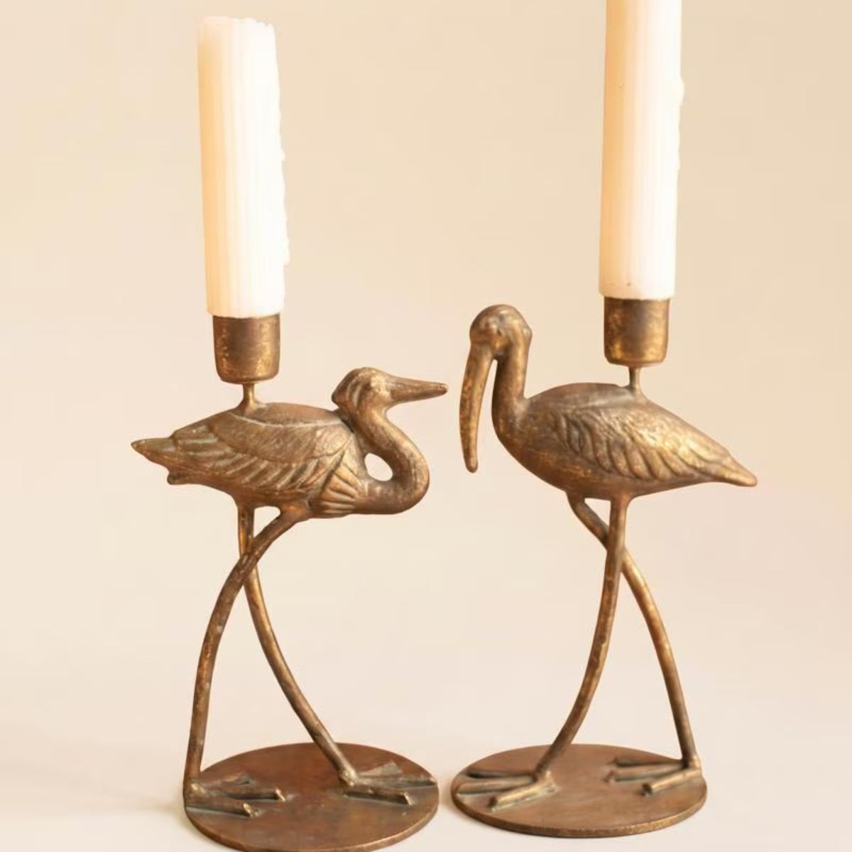 Two shore bird taper candle holders on a white background