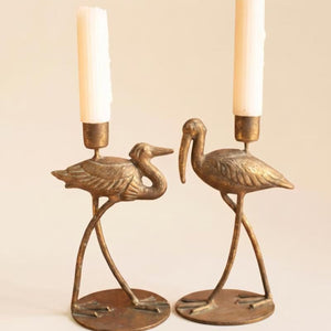 Two shore bird taper candle holders on a white background
