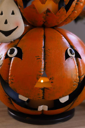 Detail of painted jack-o-lantern face with distressed orange finish